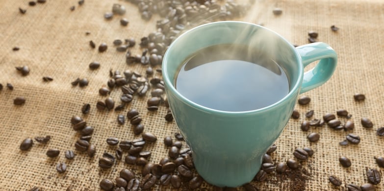 cup of coffee with coffee beans