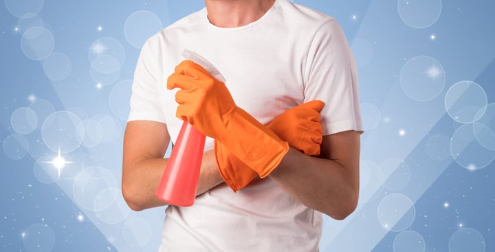 Glittered blue background with male housekeeper and cleaning equipment